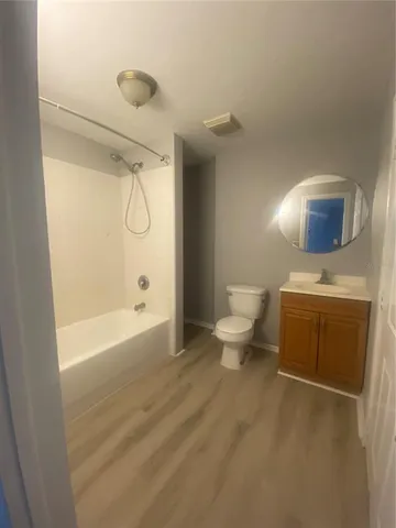 a bathroom with a toilet a sink and bathtub