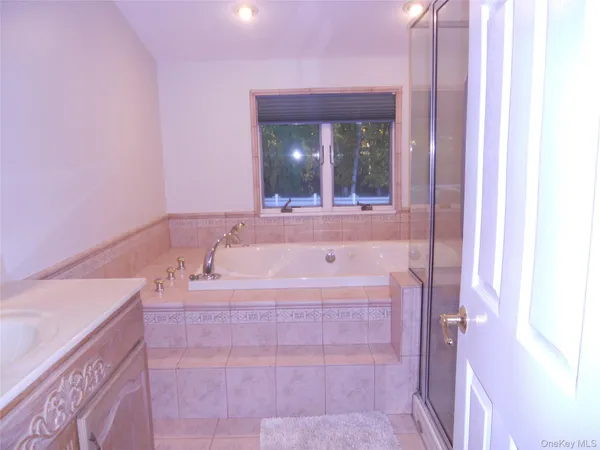 a bathroom with a bathtub and a sink