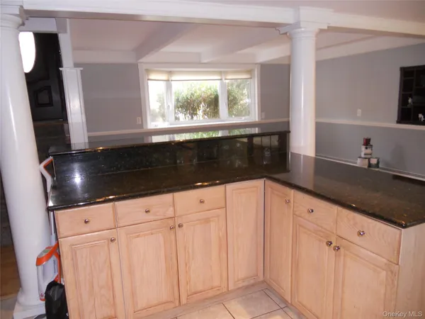 a kitchen with granite countertop white cabinets and sink