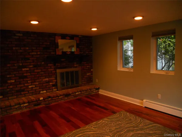a room with hard wood floors and a fireplace