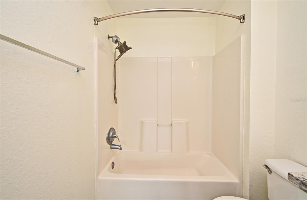 5467 Vineland Road, Unit 6308 Orlando, FL 32811 - Photo 12 of 39 a bathroom with a shower and a bath tub