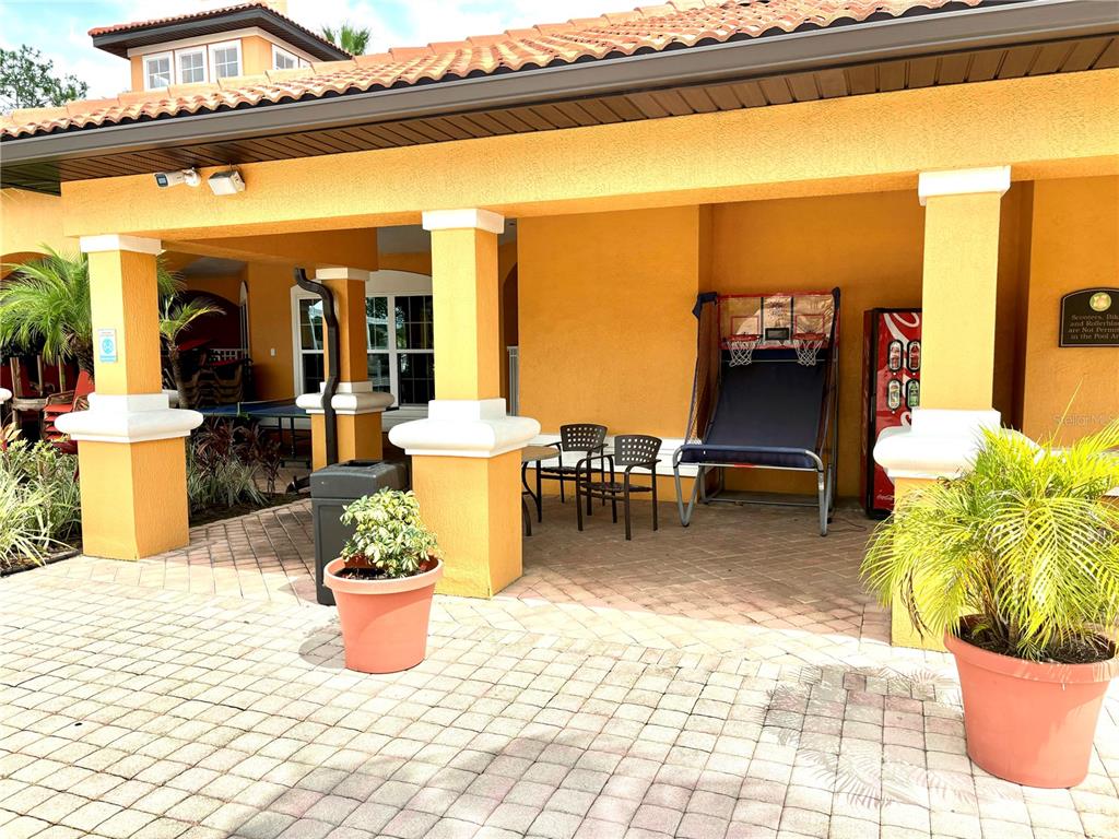 5467 Vineland Road, Unit 6308 Orlando, FL 32811 - Photo 37 of 39 a view of a patio with a dining table and chairs