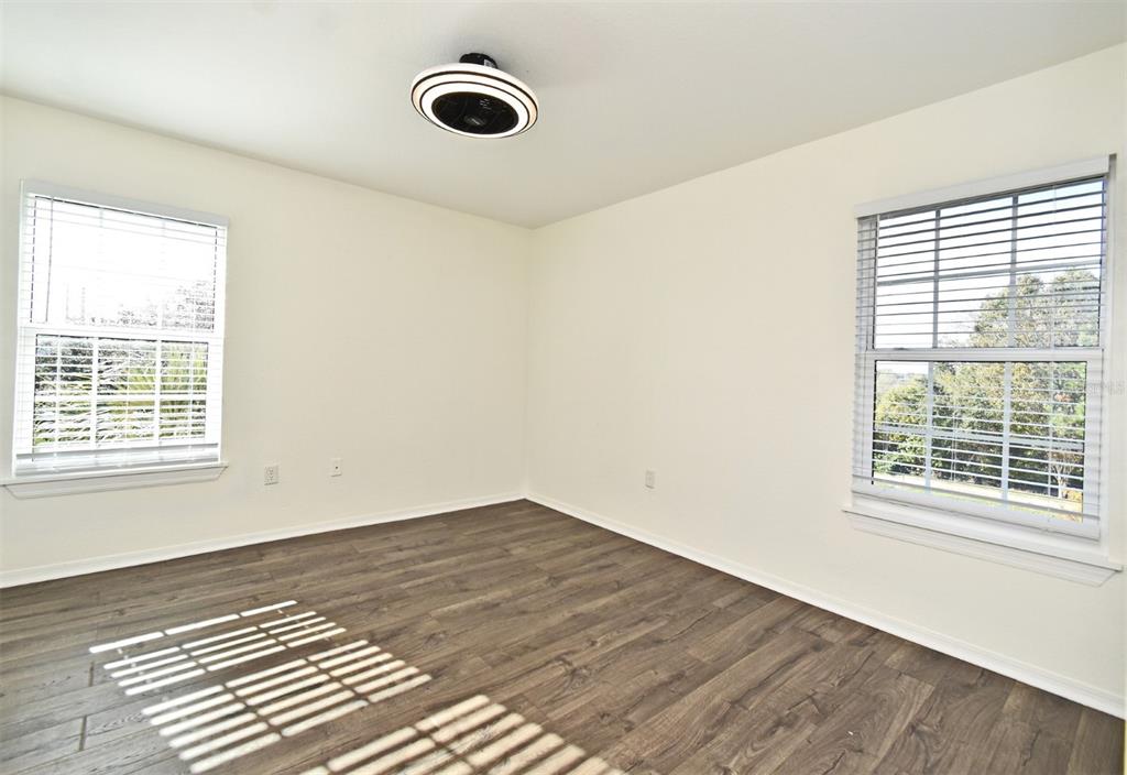 5467 Vineland Road, Unit 6308 Orlando, FL 32811 - Photo 7 of 39 a view of an empty room with wooden floor and a window