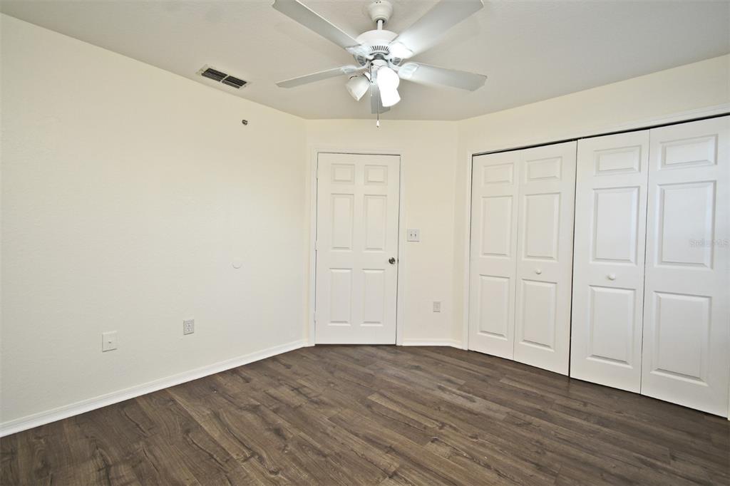 5467 Vineland Road, Unit 6308 Orlando, FL 32811 - Photo 8 of 39 a view of an empty room with wooden floor