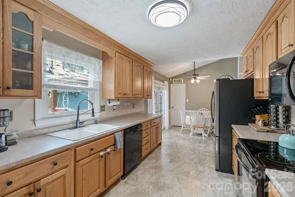a kitchen with stainless steel appliances a sink stove and refrigerator