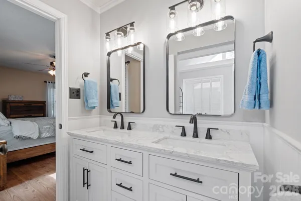 a bathroom with double vanity sink and a mirror