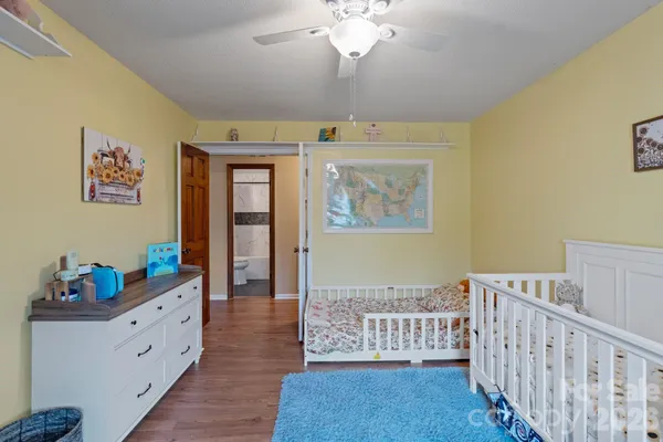 a living room with furniture and baby crib