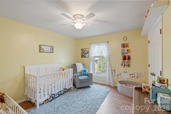 a bedroom with a bed and a flat screen tv on dresser