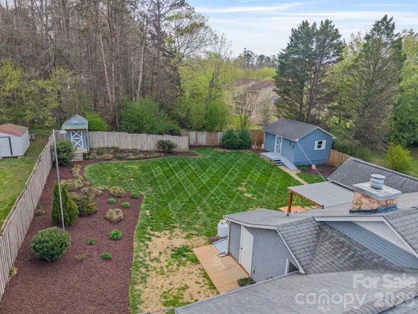 an aerial view of a house with a yard