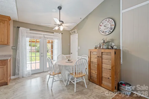 a dining room with a wooden table and chairs