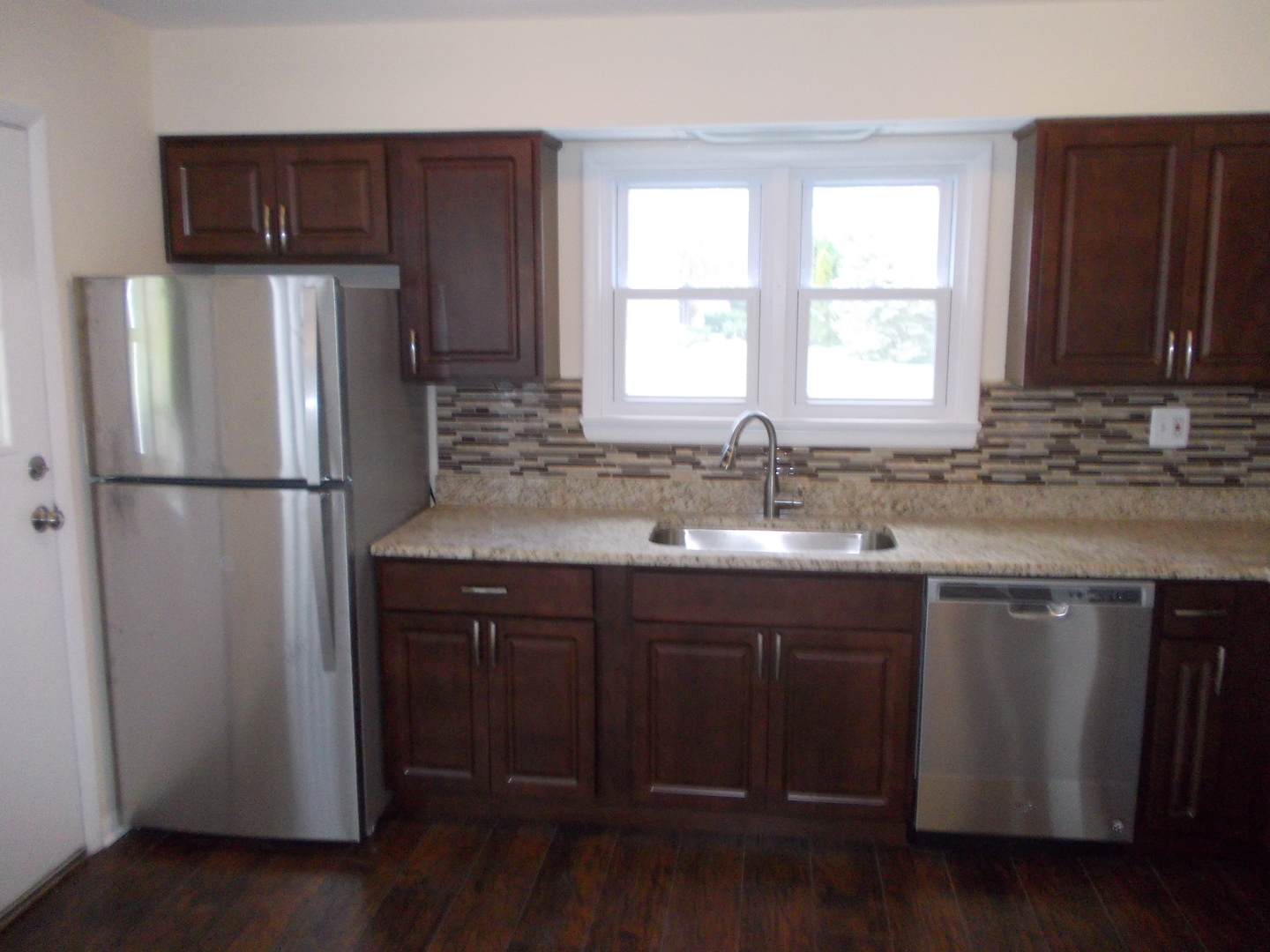 3435 Flossmoor Road Homewood, IL 60430 - Photo 6 of 13 a kitchen with a sink a window and refrigerator