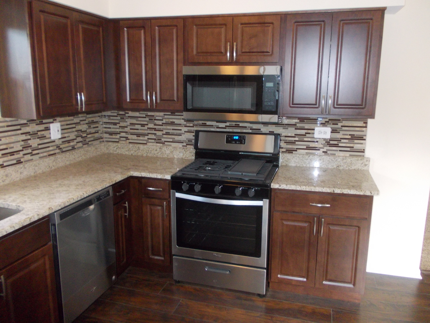 3435 Flossmoor Road Homewood, IL 60430 - Photo 7 of 13 a kitchen with granite countertop a stove and a microwave