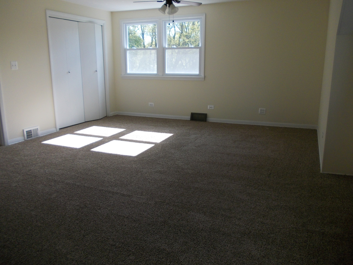 3435 Flossmoor Road Homewood, IL 60430 - Photo 10 of 13 an empty room with windows and chandelier fan