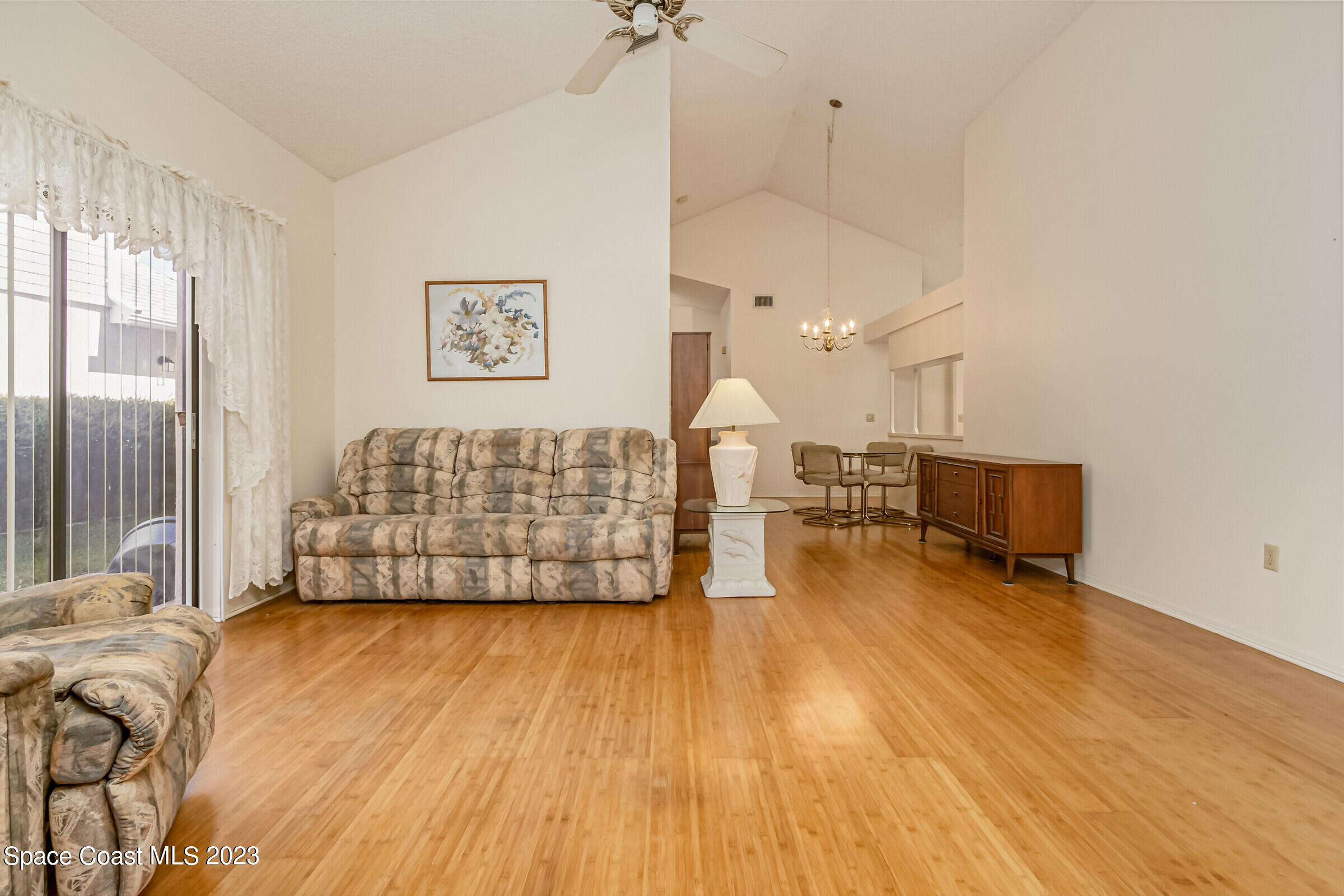 2332 Skywind Circle Melbourne, FL 32935 - Photo 12 of 34 a living room with couches chairs and wooden floor
