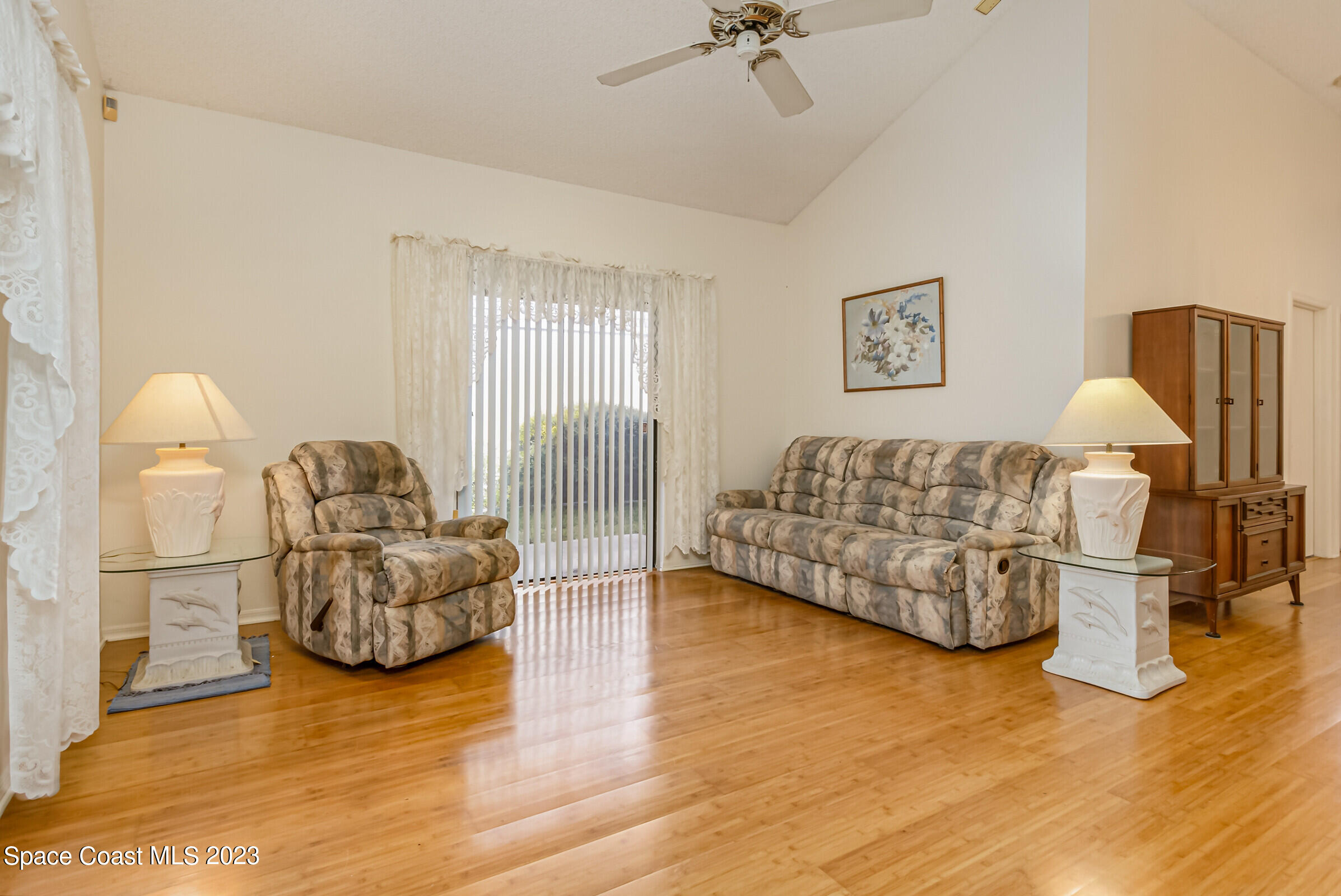 2332 Skywind Circle Melbourne, FL 32935 - Photo 13 of 34 a living room with furniture and a wooden floor