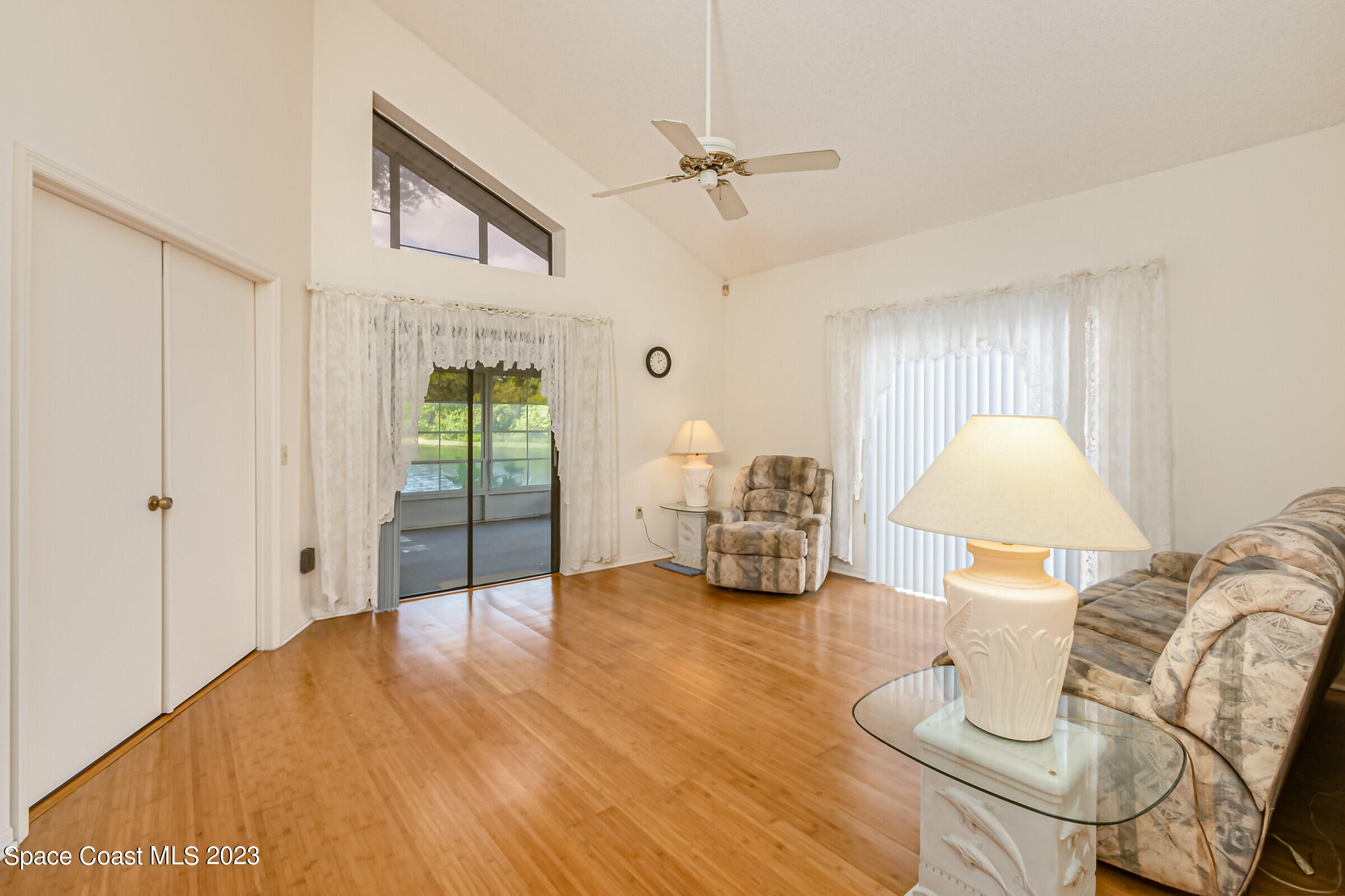 2332 Skywind Circle Melbourne, FL 32935 - Photo 14 of 34 a spacious bedroom with bed and a lamp