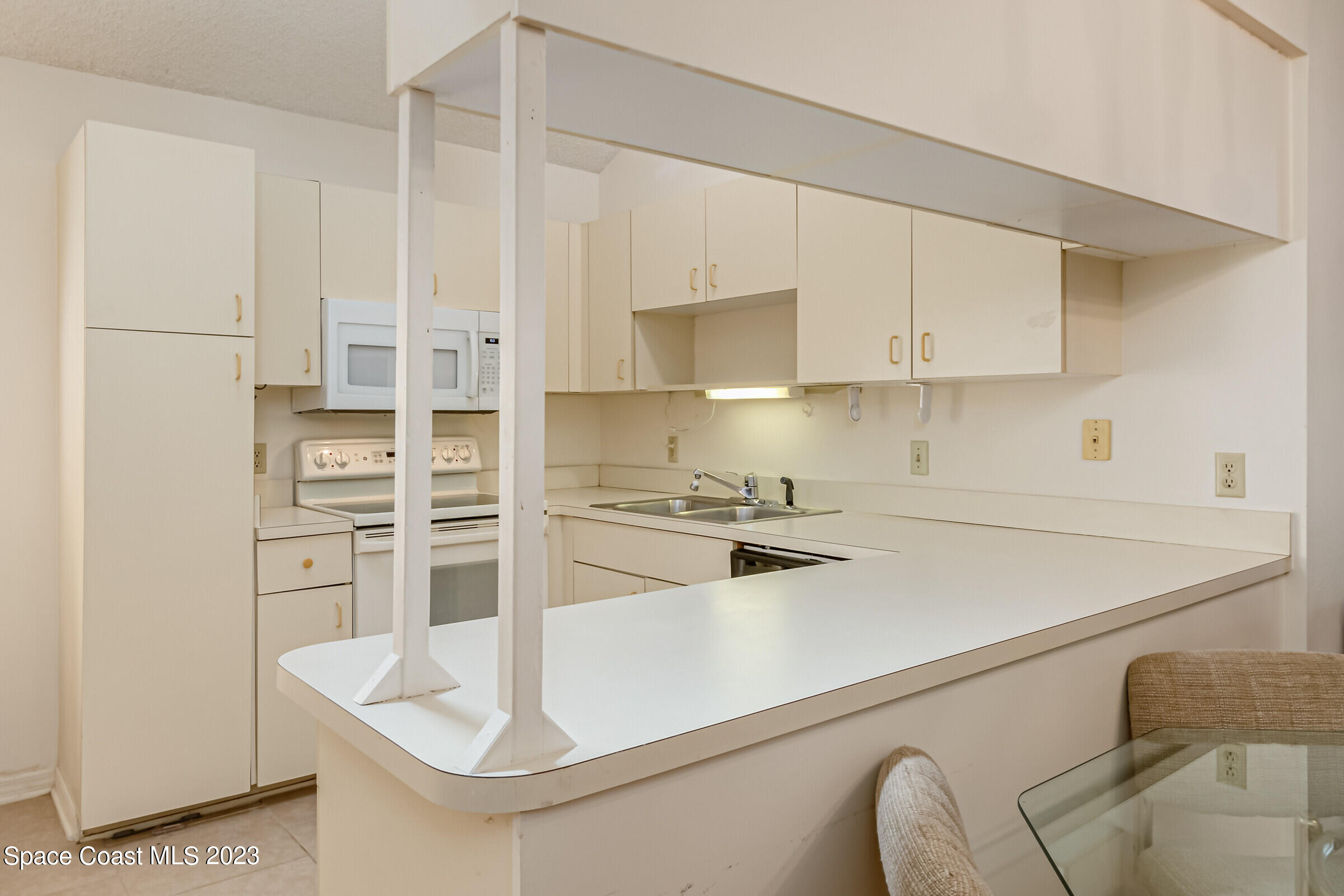 2332 Skywind Circle Melbourne, FL 32935 - Photo 15 of 34 a kitchen with stainless steel appliances a refrigerator sink and cabinets