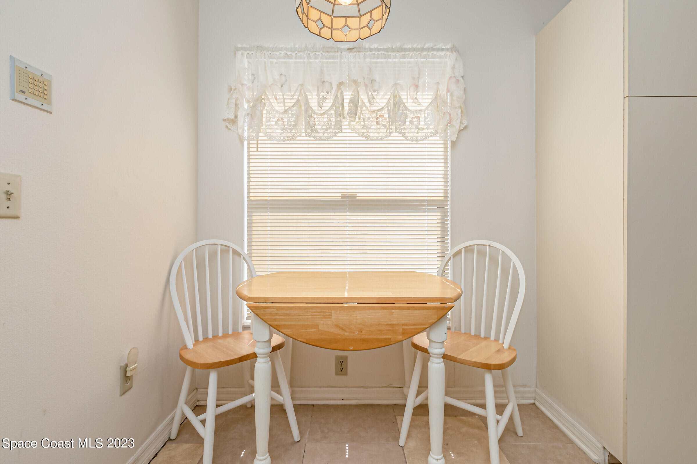 2332 Skywind Circle Melbourne, FL 32935 - Photo 18 of 34 a view of a dining room with furniture and window
