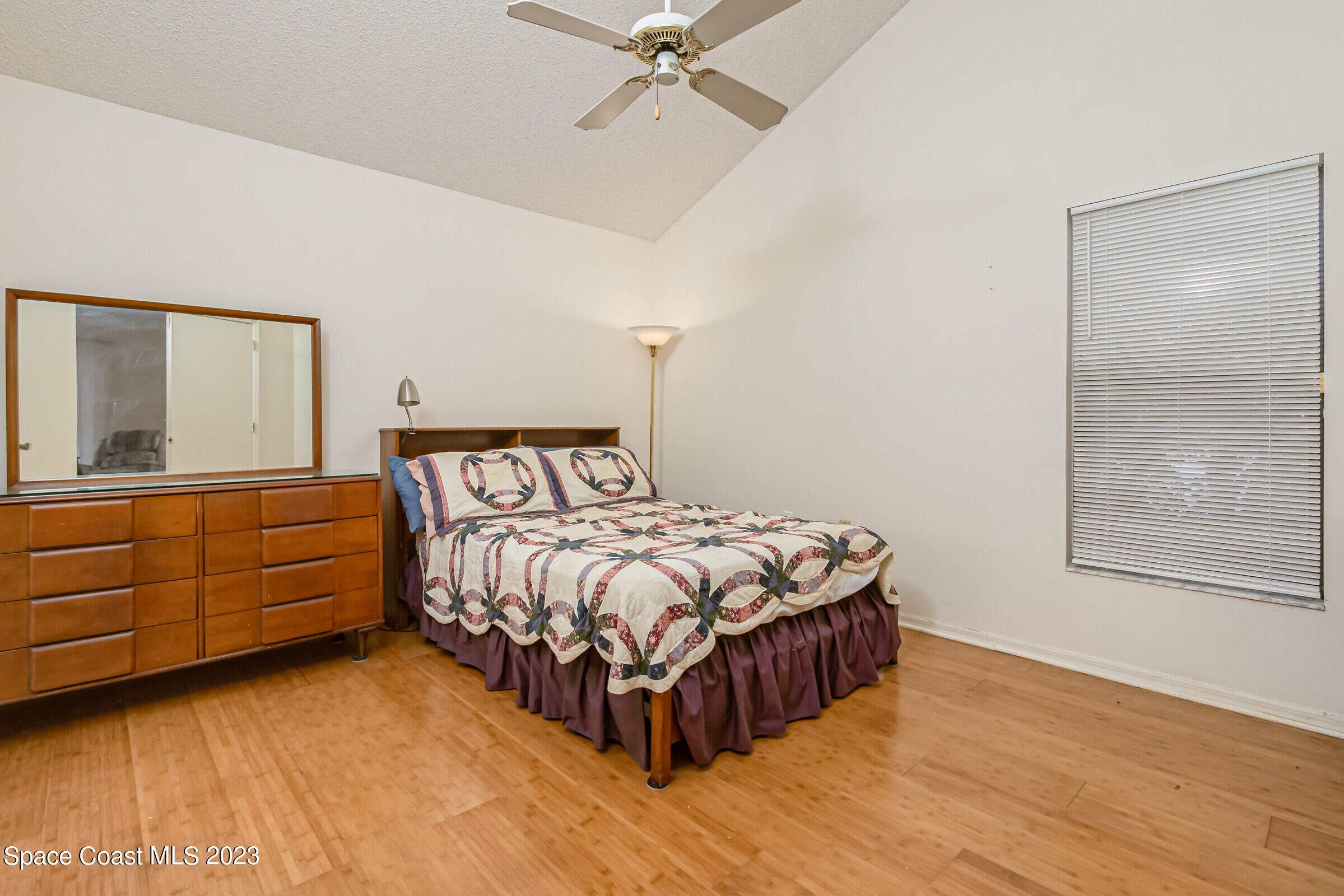 2332 Skywind Circle Melbourne, FL 32935 - Photo 25 of 34 a bedroom with a bed and a dresser