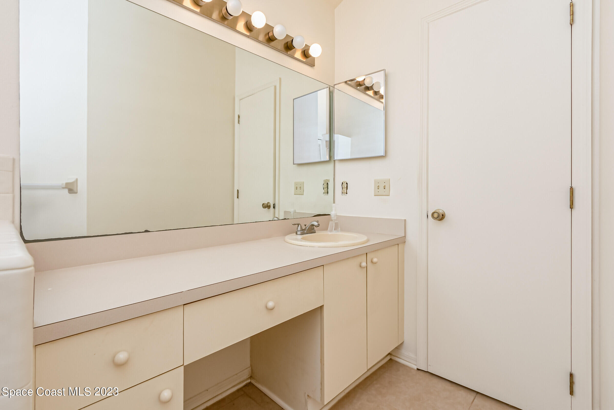 2332 Skywind Circle Melbourne, FL 32935 - Photo 27 of 34 a bathroom with a sink and a mirror