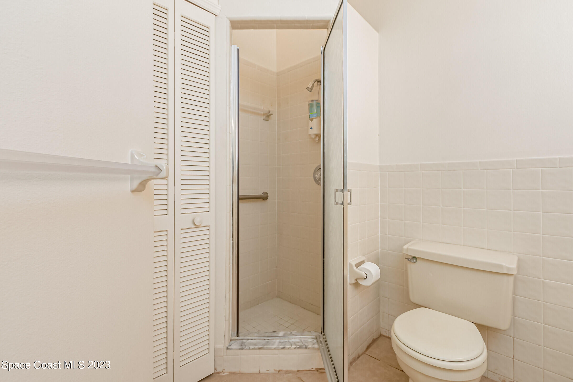 2332 Skywind Circle Melbourne, FL 32935 - Photo 29 of 34 a bathroom with a toilet and a shower