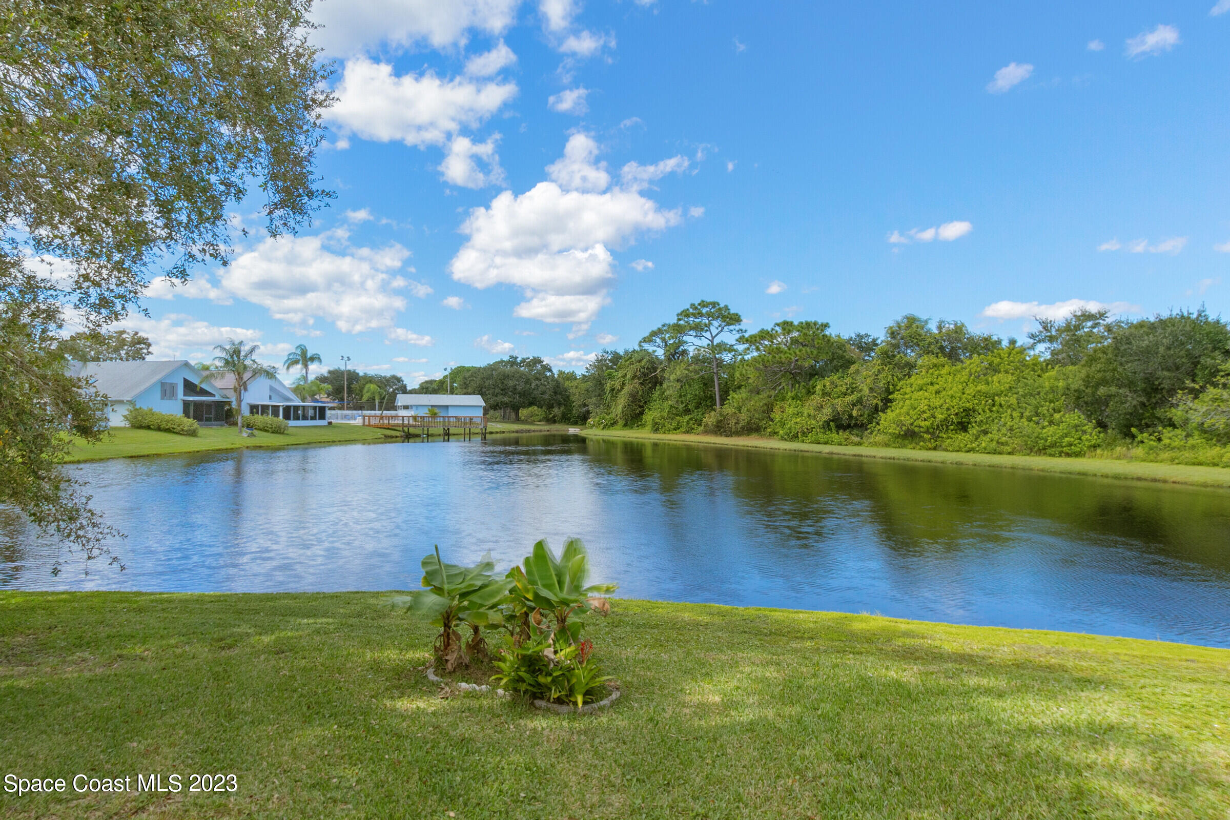 2332 Skywind Circle Melbourne, FL 32935 - Photo 8 of 34 a view of a lake with a yard