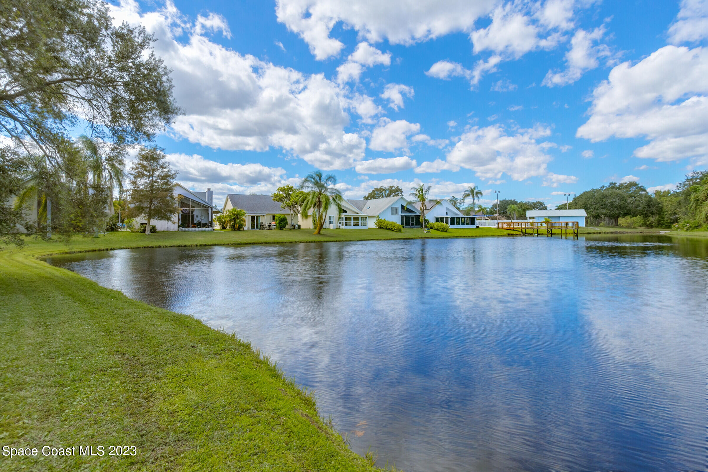 2332 Skywind Circle Melbourne, FL 32935 - Photo 9 of 34 a view of a lake with houses in the back