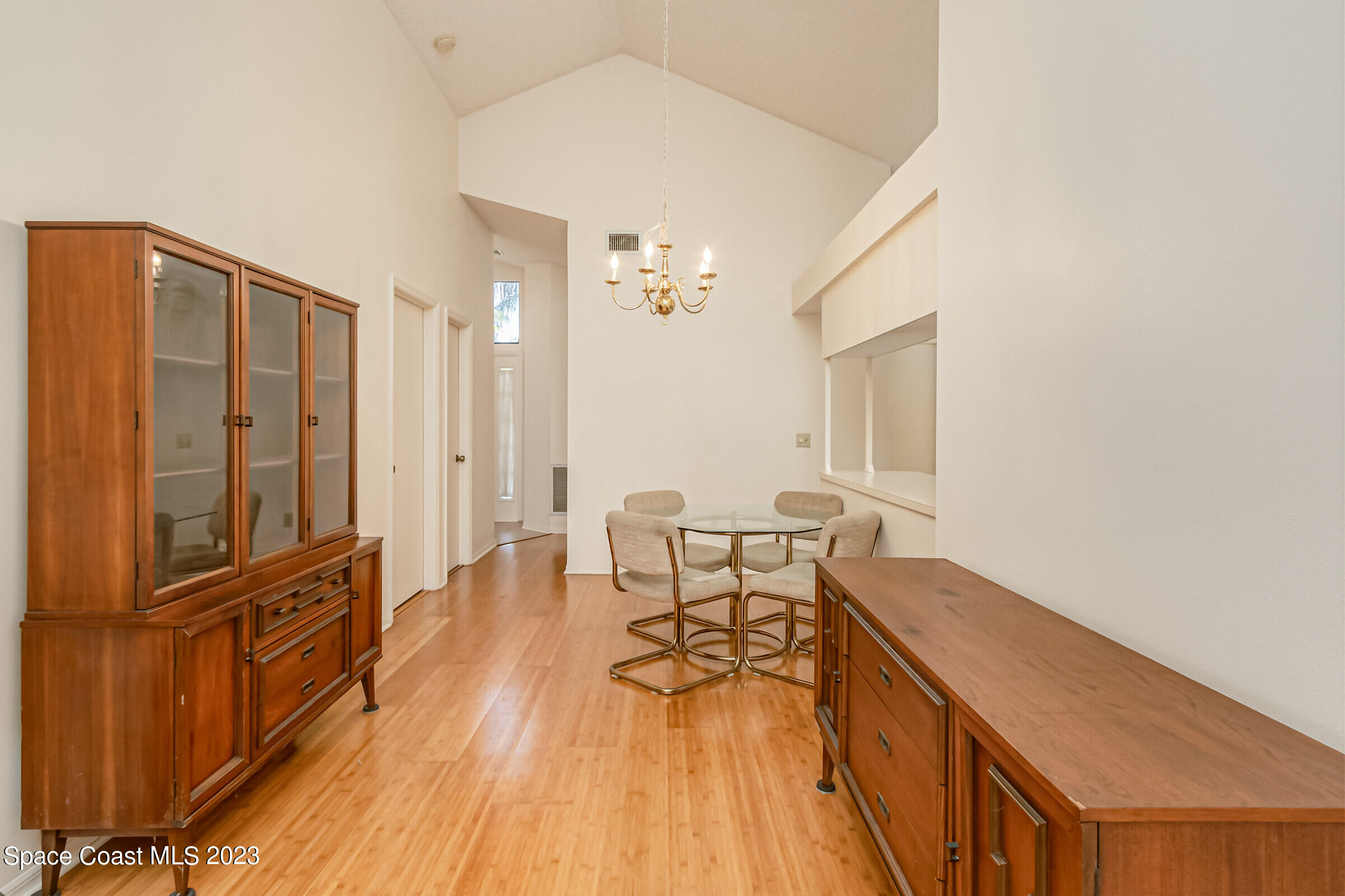 2332 Skywind Circle Melbourne, FL 32935 - Photo 10 of 34 a view of a dining room with furniture and wooden floor