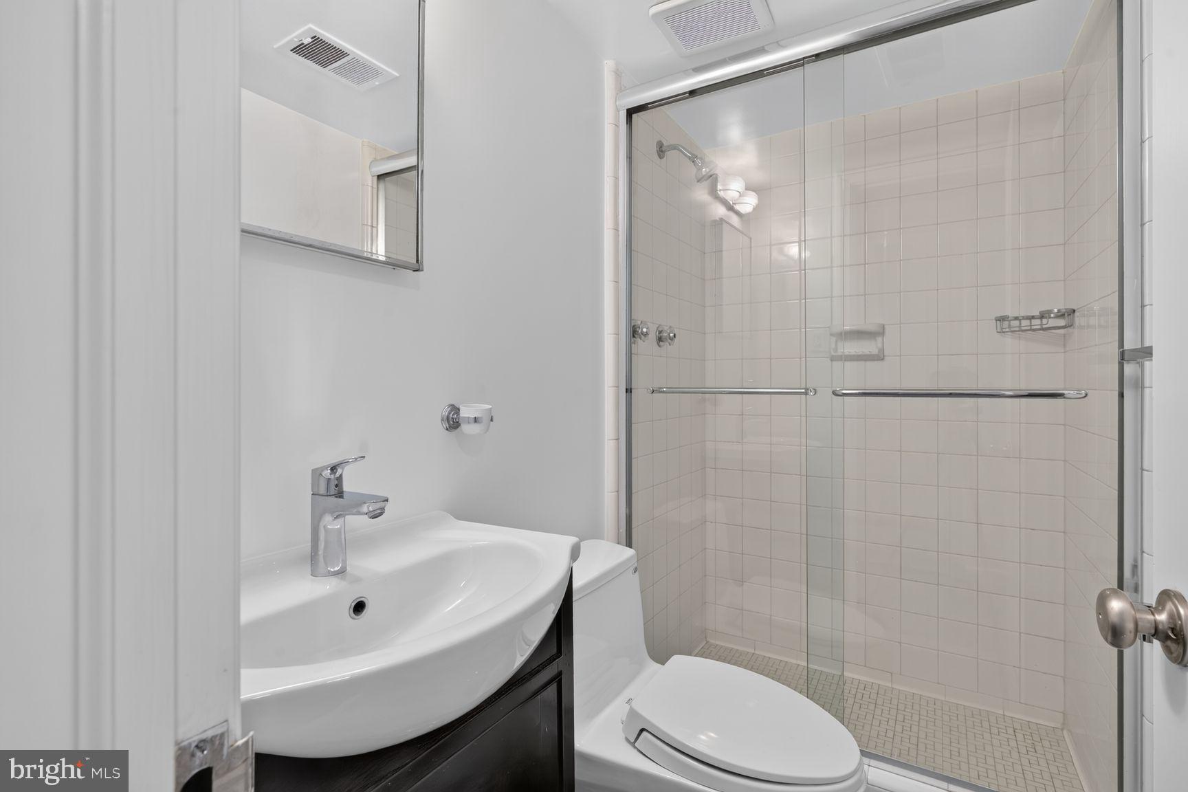 4605 Reno Road Northwest Washington, DC 20008 - Photo 26 of 49 a bathroom with a sink toilet and shower