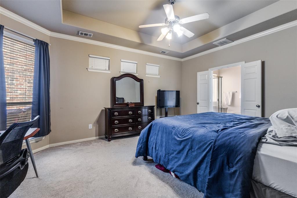 1046 Gold Camp Road Frisco, TX 75033 - Photo 11 of 25 a bedroom with a bed a chandelier and dresser