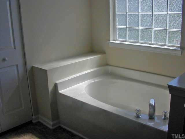 404 Hanson Road Durham, NC 27713 - Photo 8 of 10 The master bathroom offers separate garden tub and shower, dual cultured marble vanities and plenty of light. Other