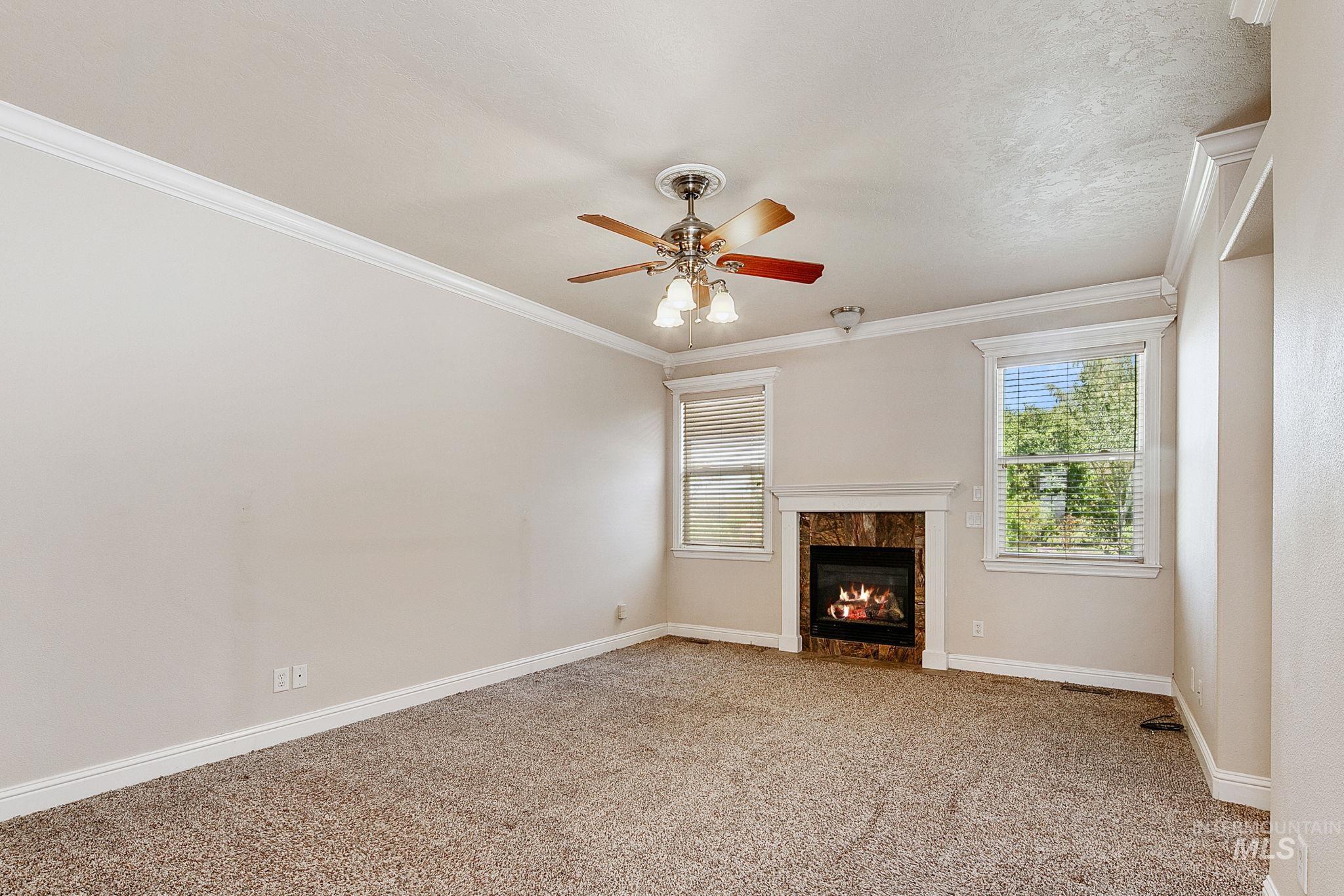 6850 Purple Sage Road Star, ID 83669 - Photo 47 of 50 High-ceiling garage space featuring a large roll-up door, polished concrete flooring, built-in cabinetry with extensive drawer storage, and a separate stairway access