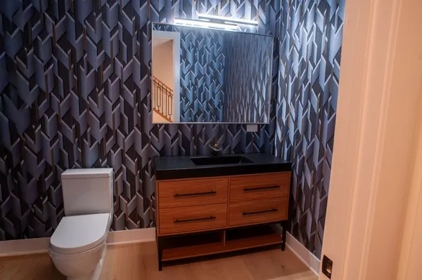 a bathroom with a toilet and a shower curtain