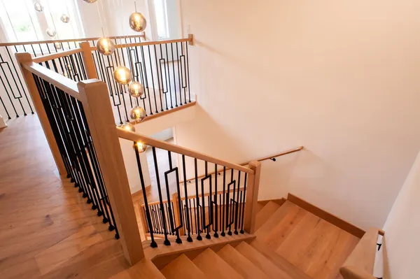 a view of staircase with railing and a rug