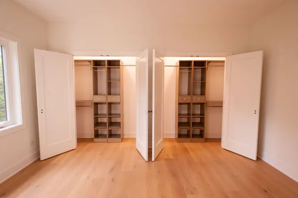a view of an empty room with closet and utility room