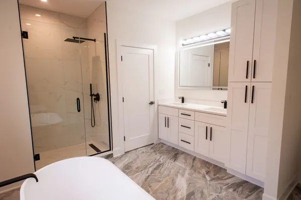 a bathroom with a sink a toilet and shower