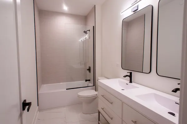 a bathroom with a sink toilet and shower
