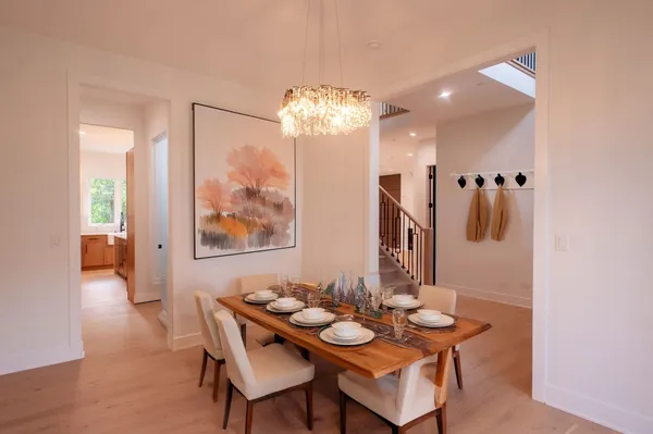 a view of a dining room with furniture and chandelier