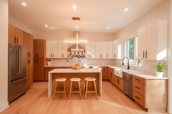 a large kitchen with a table and chairs