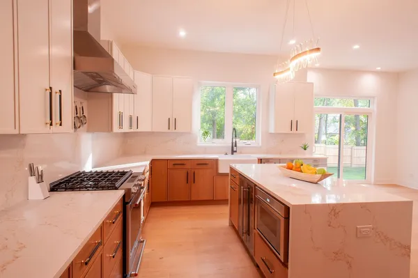 a kitchen with a sink a stove and a window