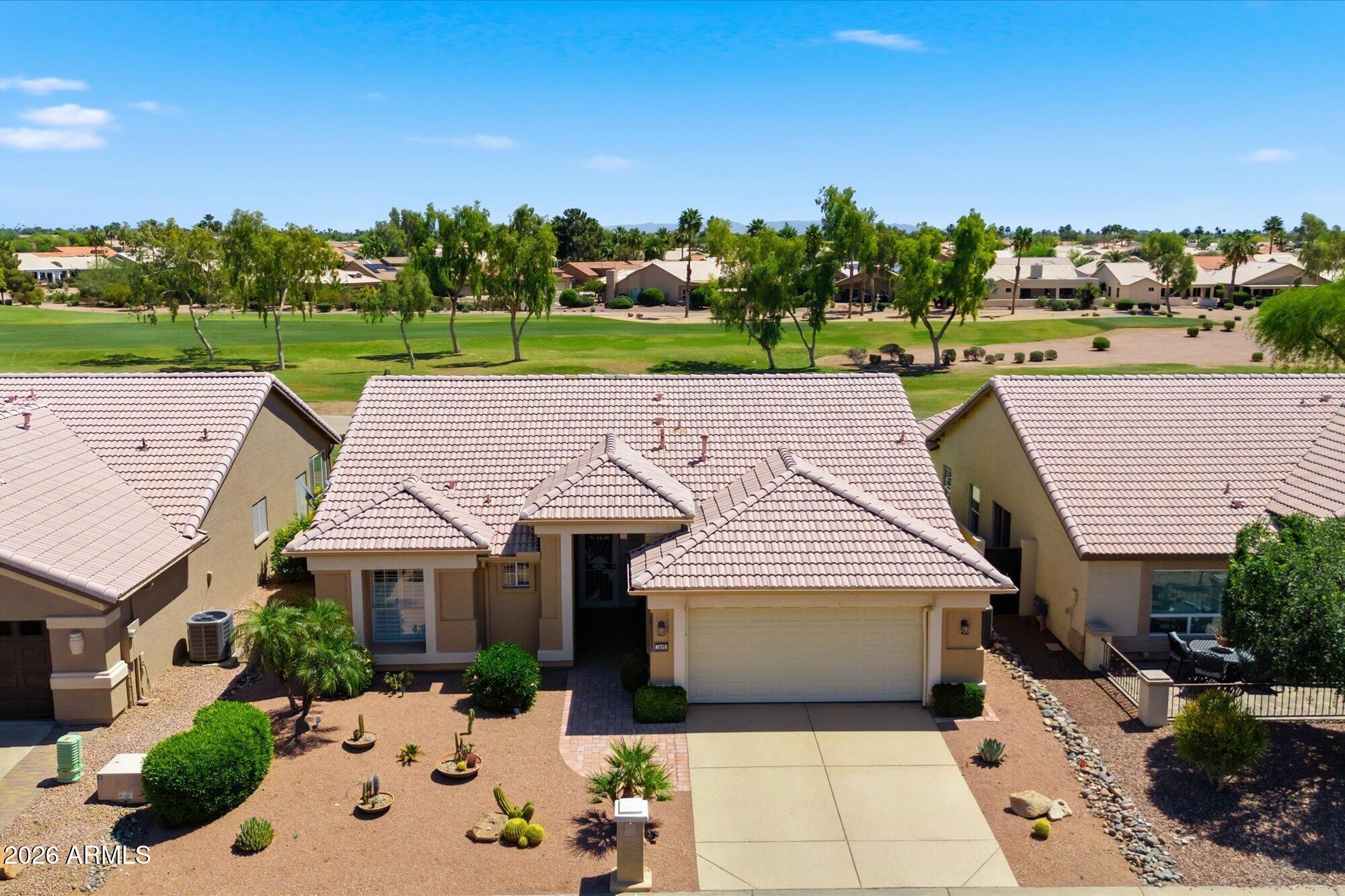 3895 North 150th Lane Goodyear, AZ 85395 - Photo 1 of 34 an aerial view of a house with big yard and large trees