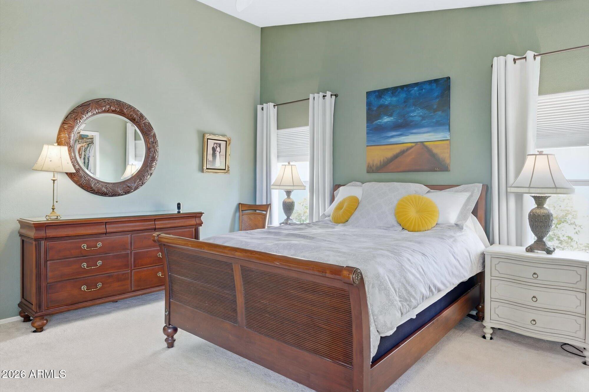 3895 North 150th Lane Goodyear, AZ 85395 - Photo 15 of 34 a bedroom with a bed and a dresser