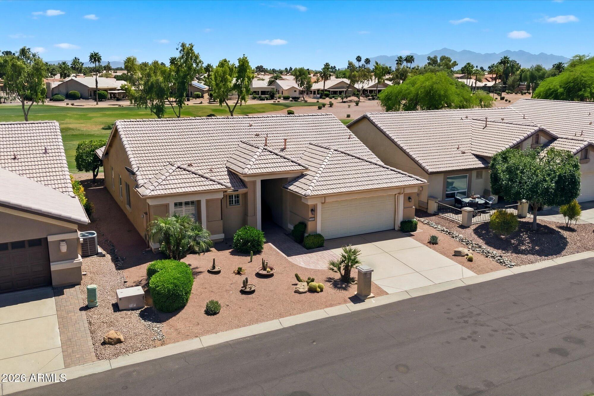 3895 North 150th Lane Goodyear, AZ 85395 - Photo 27 of 34 an aerial view of a house with yard and mountain view in back