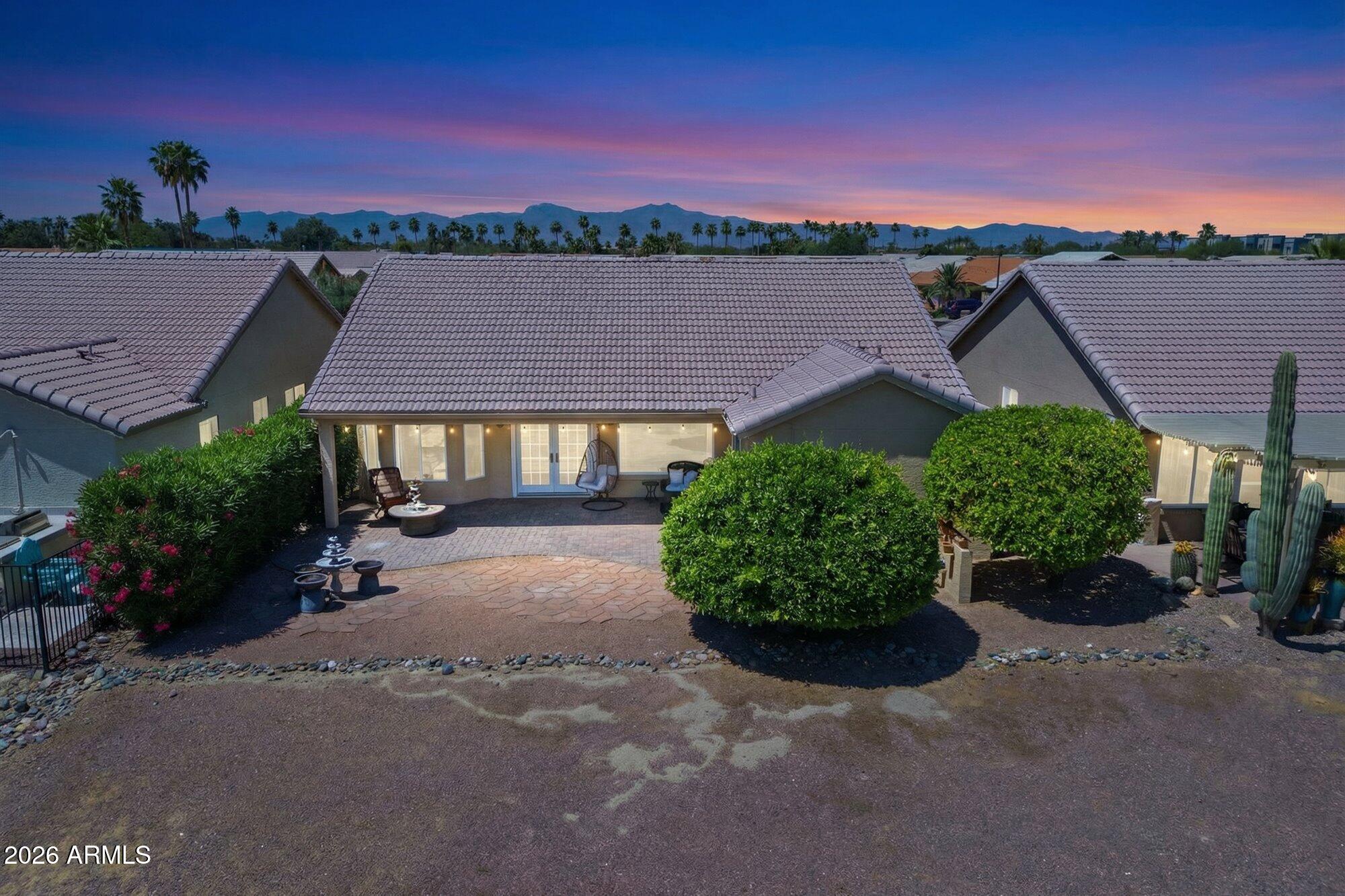 3895 North 150th Lane Goodyear, AZ 85395 - Photo 29 of 34 a view of a house with a yard and a table
