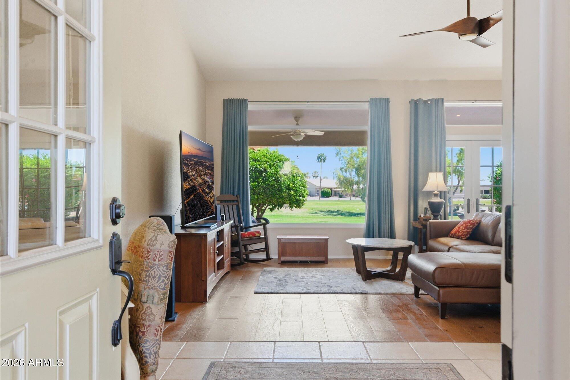 3895 North 150th Lane Goodyear, AZ 85395 - Photo 3 of 34 a living room with furniture and a large window