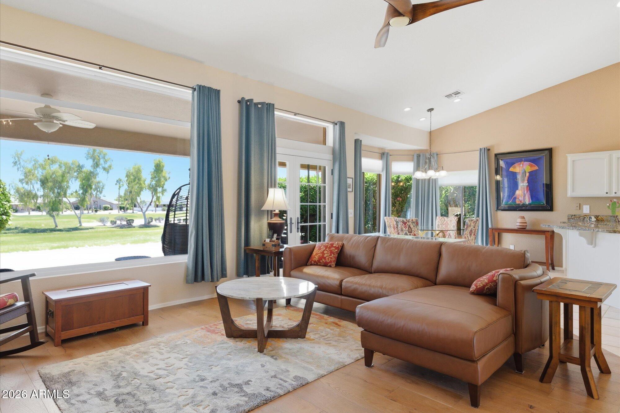 3895 North 150th Lane Goodyear, AZ 85395 - Photo 4 of 34 a living room with furniture and a large window