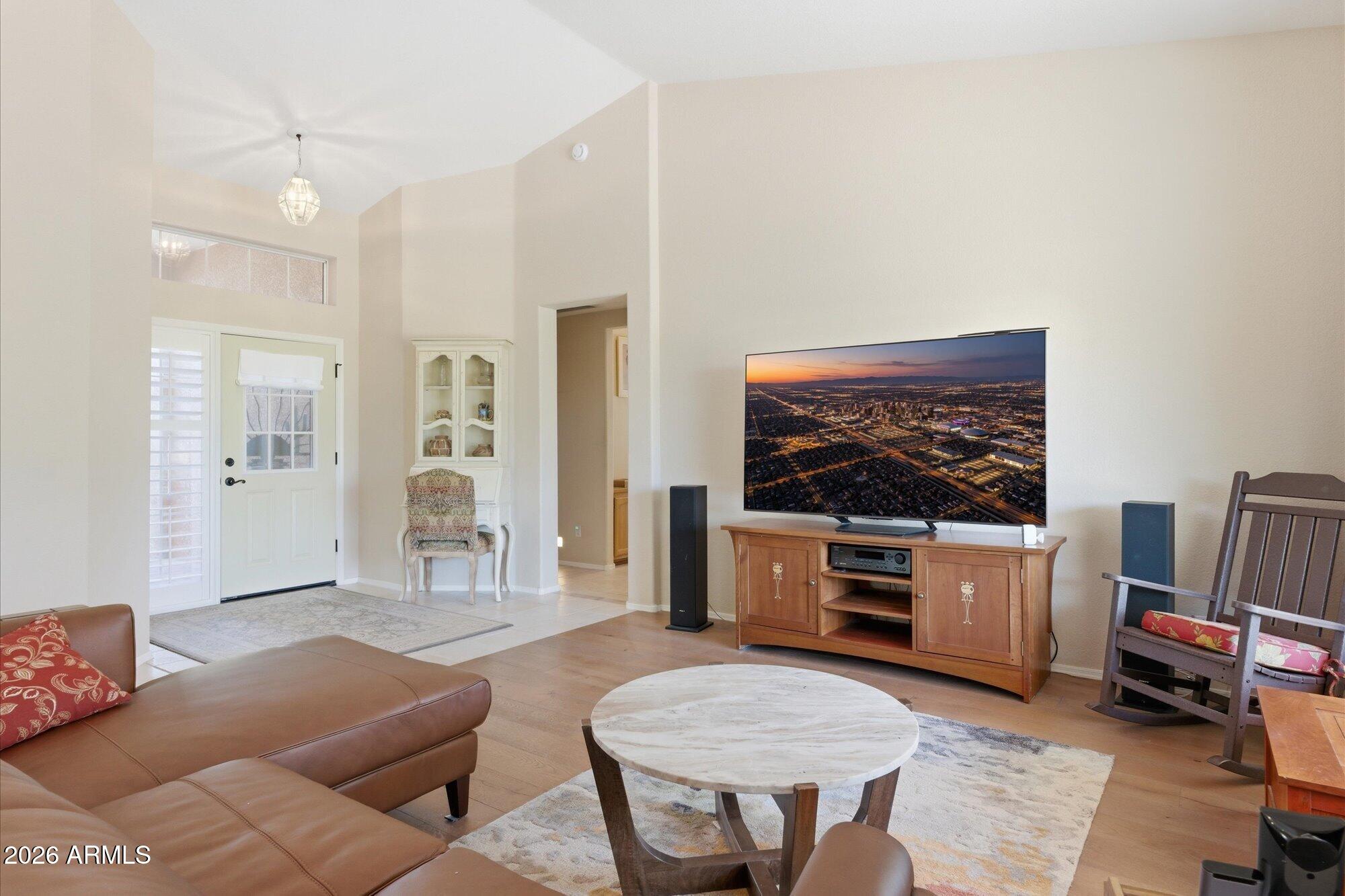 3895 North 150th Lane Goodyear, AZ 85395 - Photo 5 of 34 a living room with furniture and a flat screen tv
