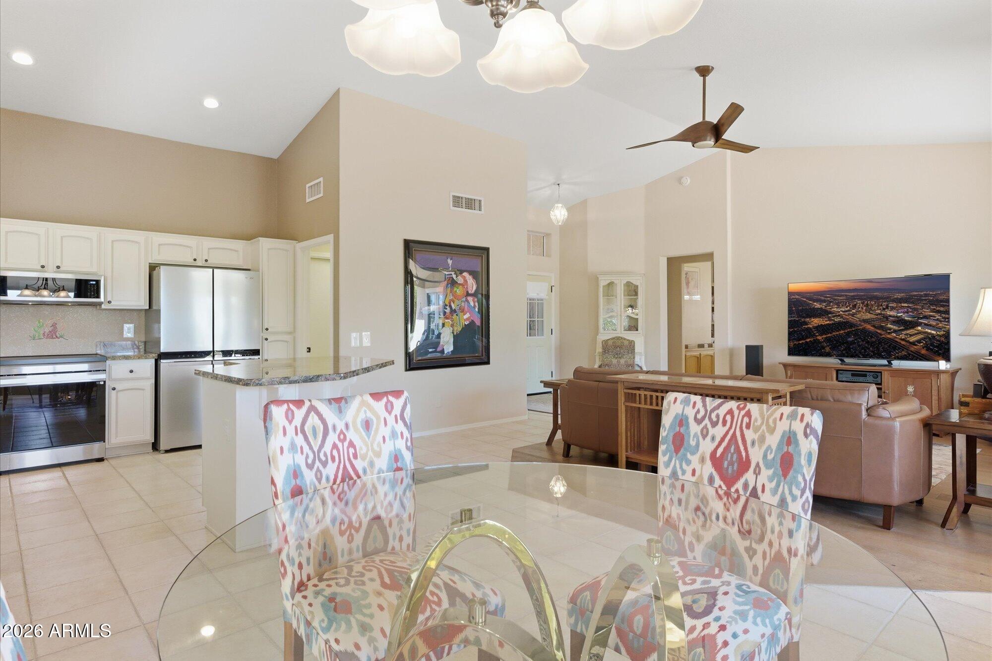 3895 North 150th Lane Goodyear, AZ 85395 - Photo 8 of 34 a living room with furniture and a flat screen tv