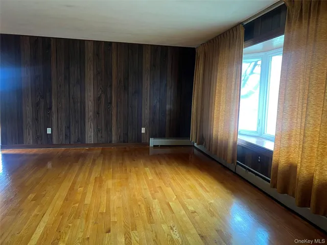 a view of room with window and wooden floor