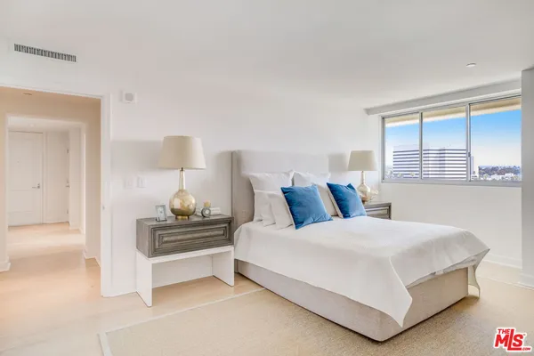 a bedroom with a bed and dresser